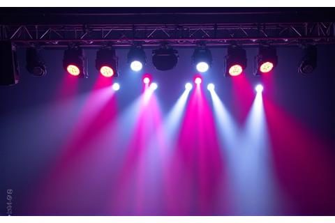 An elaborate overhead stage lighting rig with moving heads and spotlights, creating dynamic visual effects.