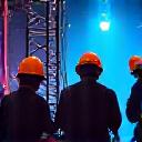 Skilled technical crew setting up equipment on a stage
